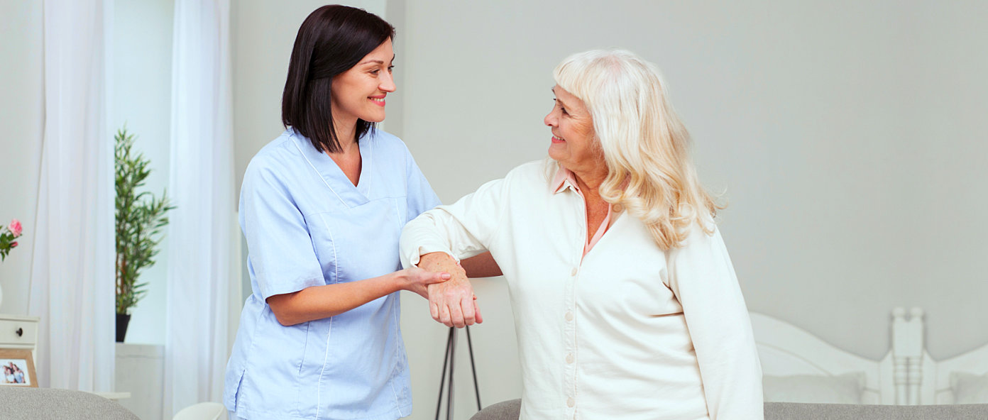 nurse assisting middle aged woman